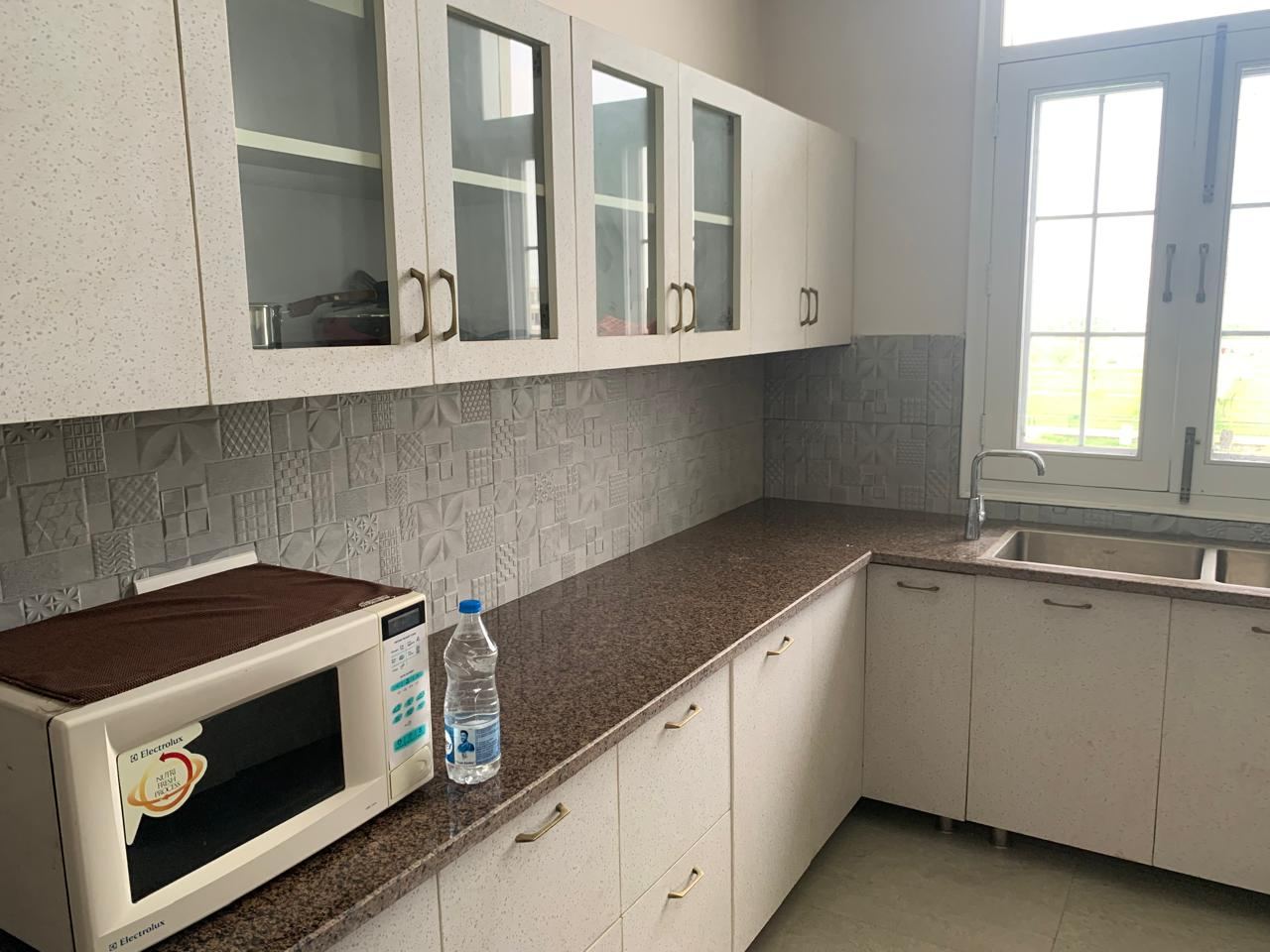 Fitted kitchen with microwave and induction